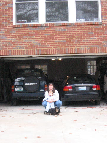 Bethany, Jane and Madie in front of the cars parked in the garage for 1st time